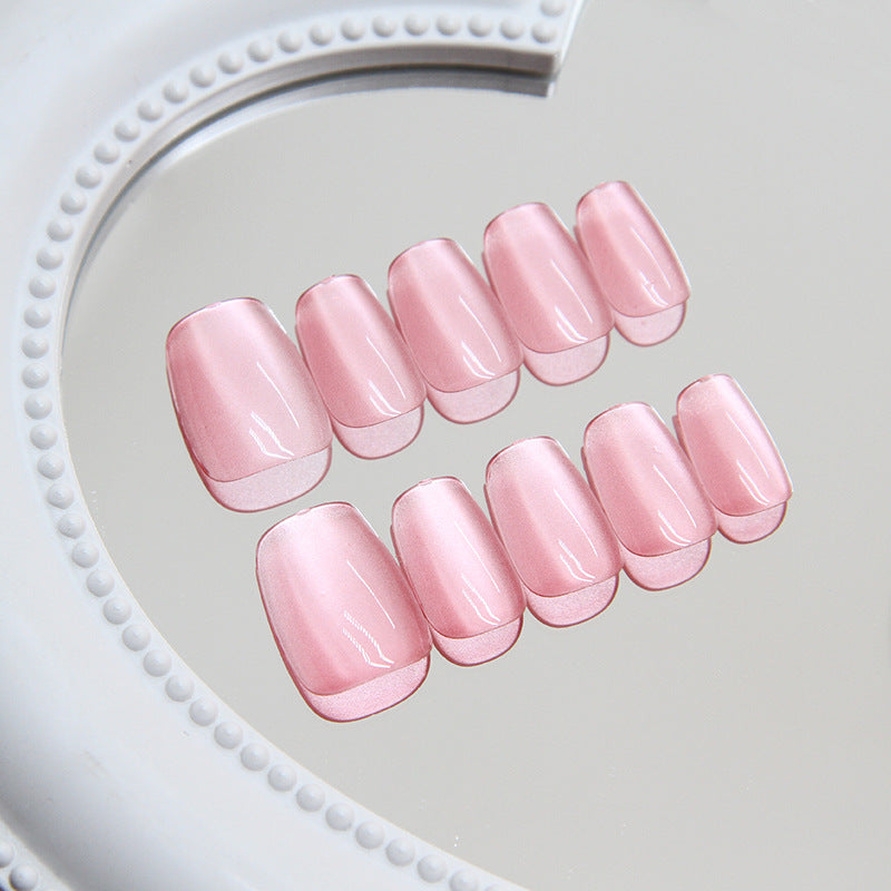Set of pink nail tips on a white heart-shaped tray