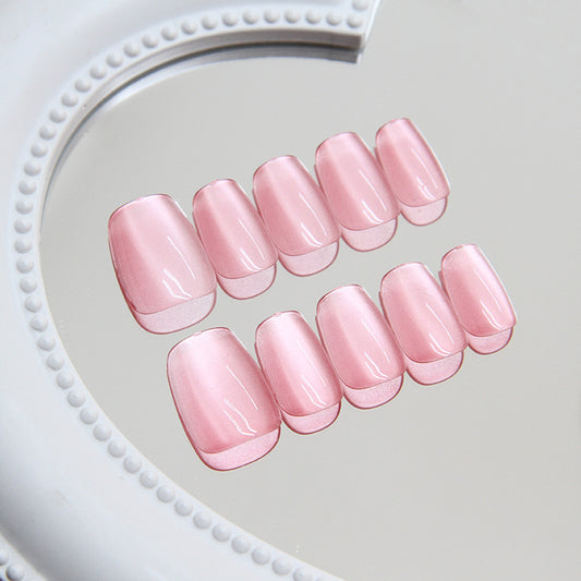 Set of pink nail tips on a white heart-shaped tray