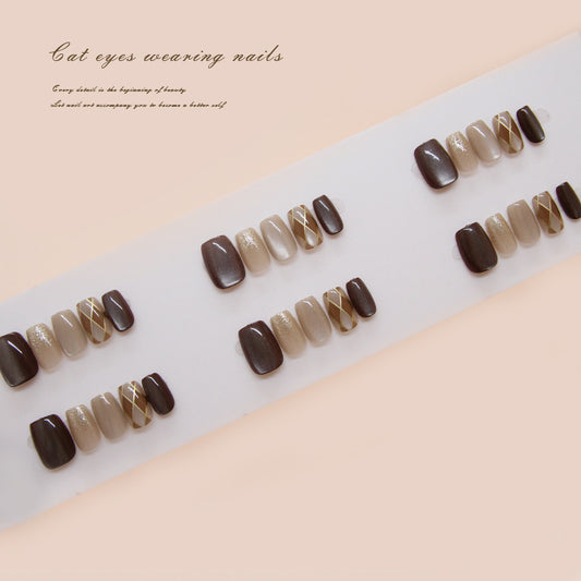 Set of brown and beige nail designs on a white tray with a beige background