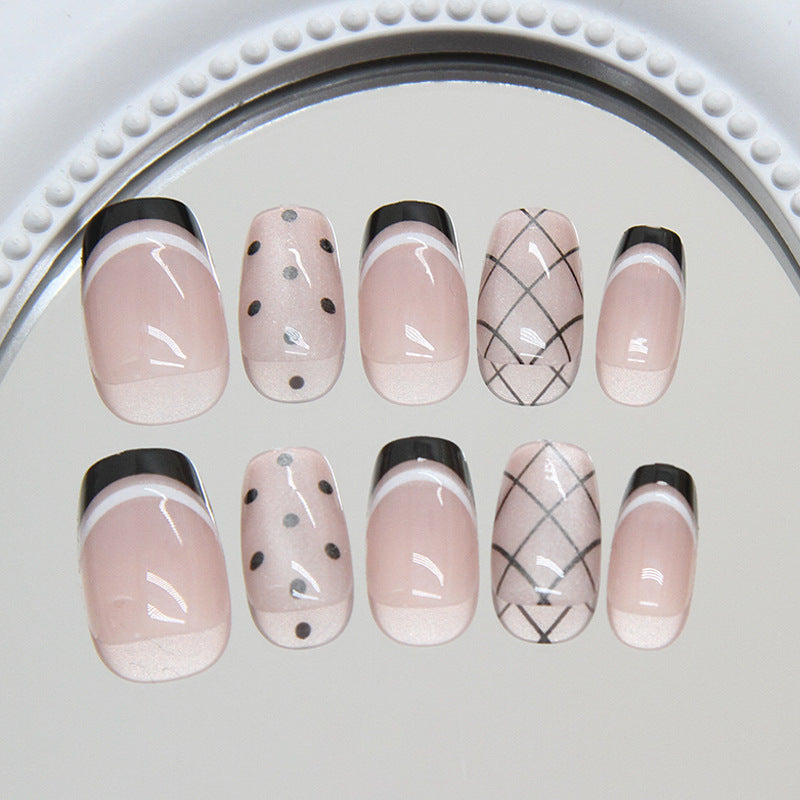 Elegant Chic Short Squoval Shaped Blush Pink Press on Nail Set with Black Accents and Trendy Patterns