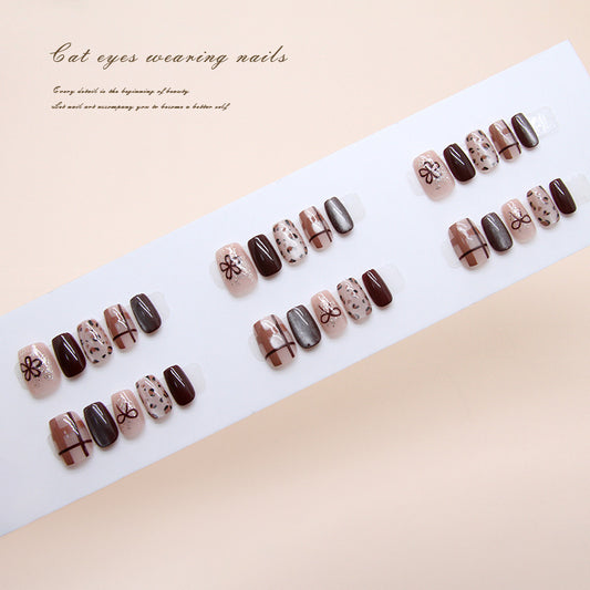 Set of nail designs on a white tray with a beige background