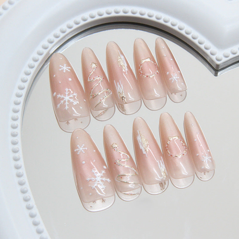 Decorative false nails with Christmas designs on a white plate