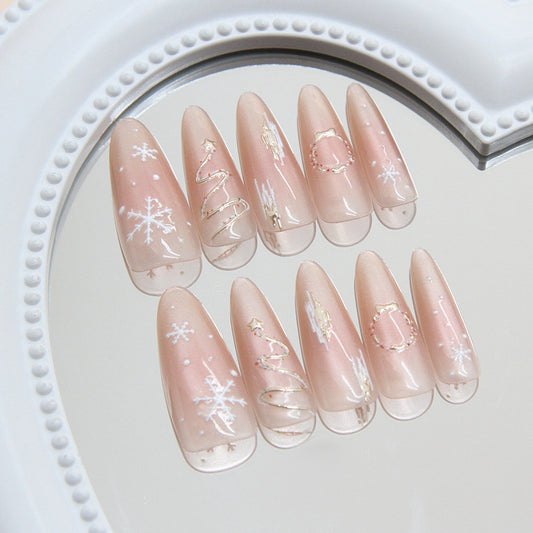 Decorative false nails with Christmas designs on a white plate