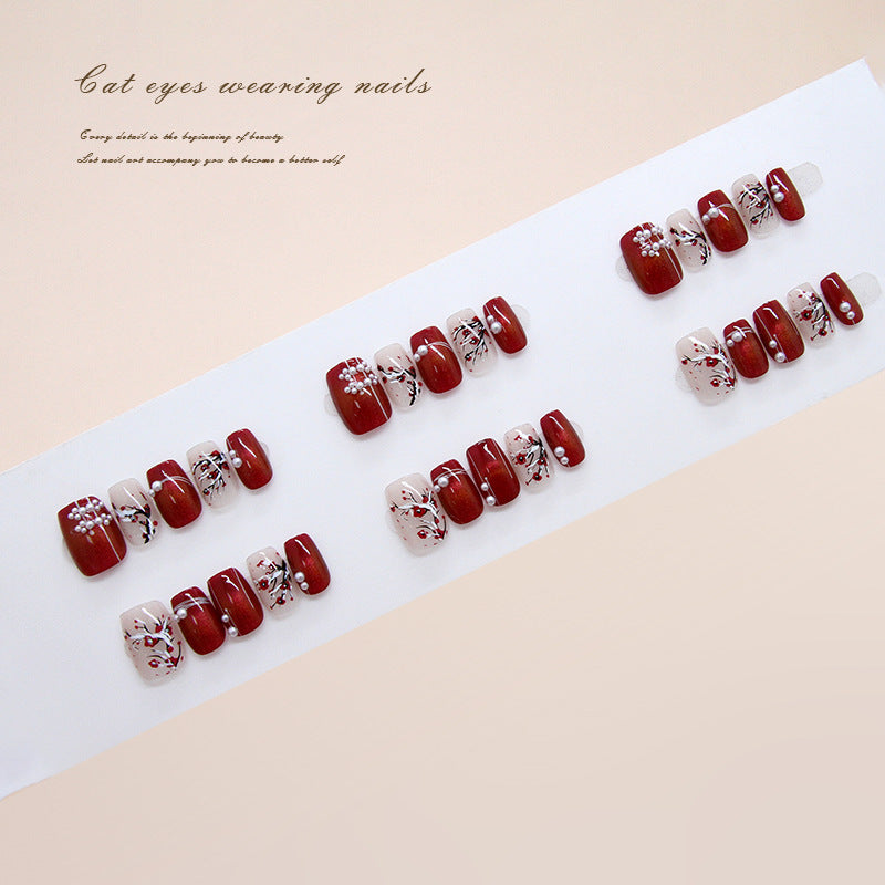 Set of red and white nail designs on a white tray with text on a beige background