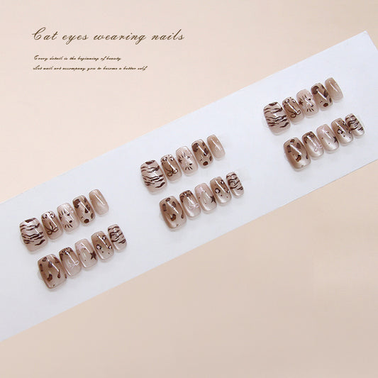 Set of nail designs on a white paper with a beige background