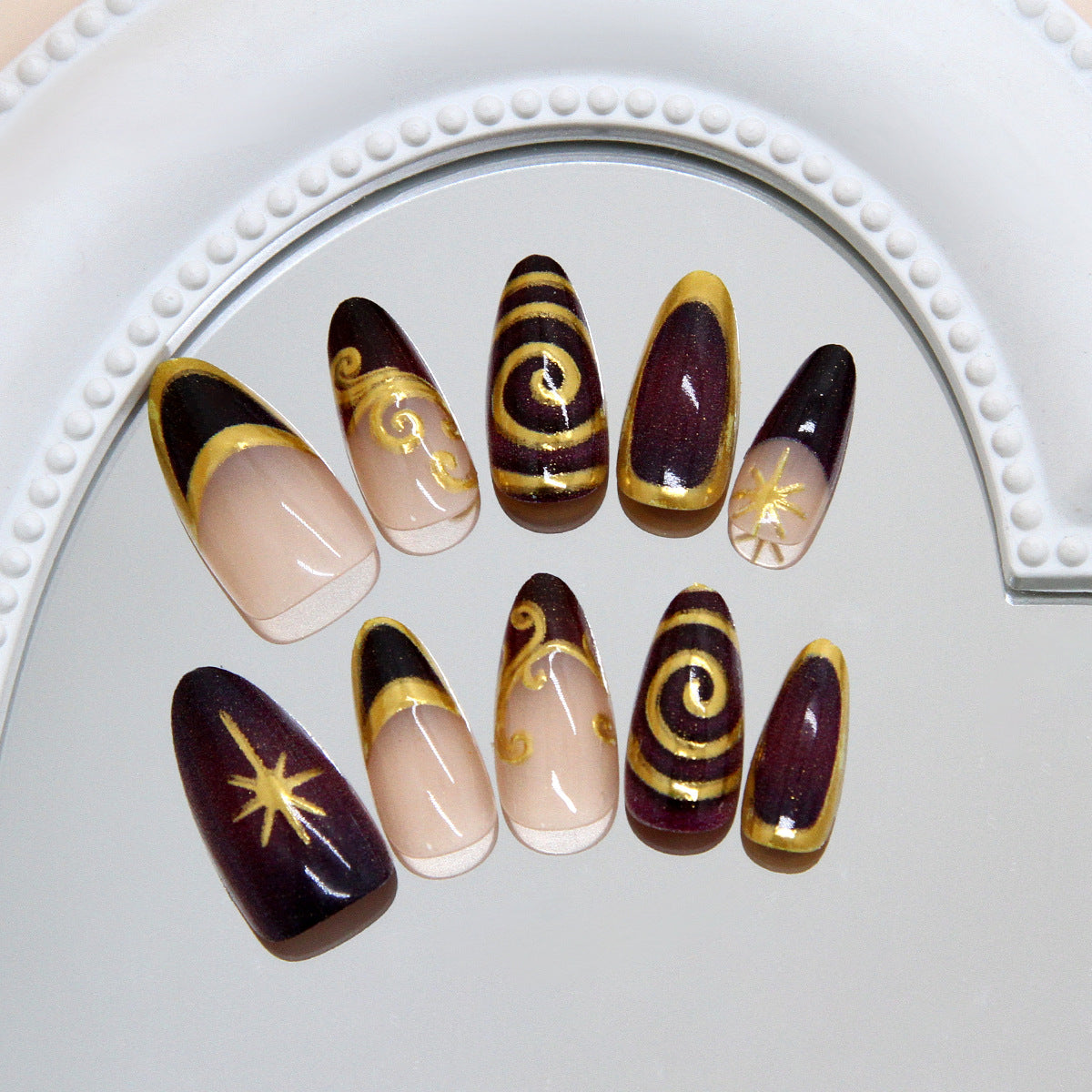 Celestial Glamour Long Almond Burgundy Press On Nail Set with Gold Accents and Intricate Swirl Designs