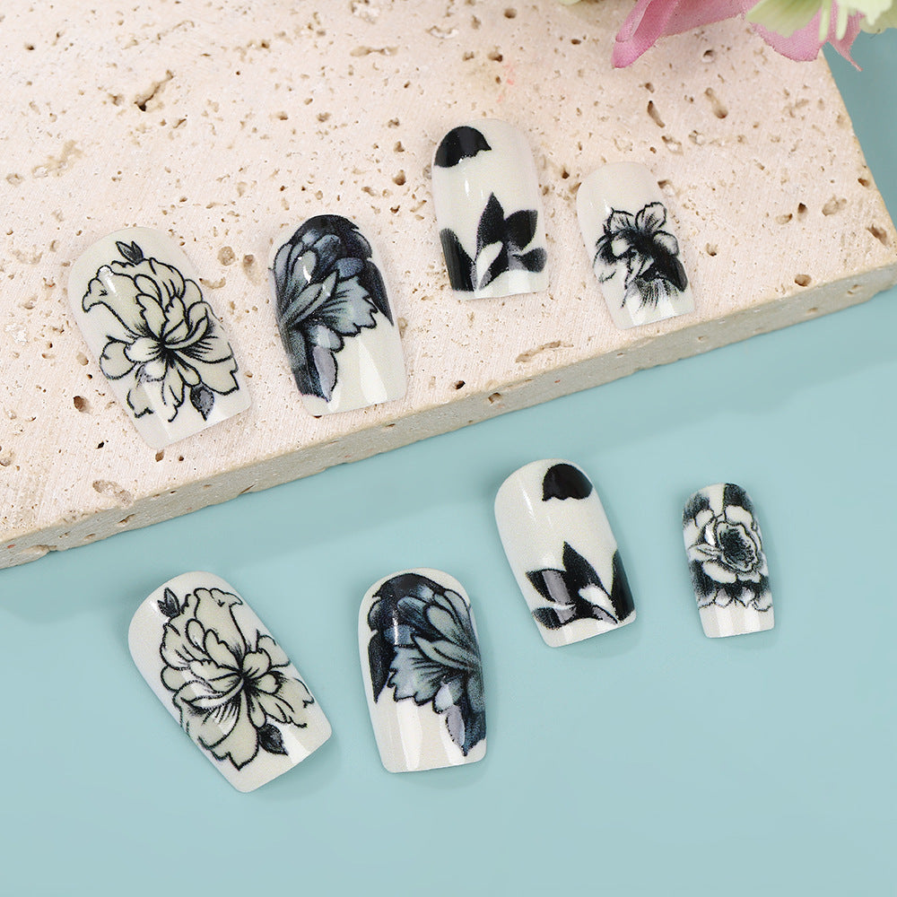 Floral Elegance Short Square White and Black Floral Press On Nail Set with Artistic Detailing