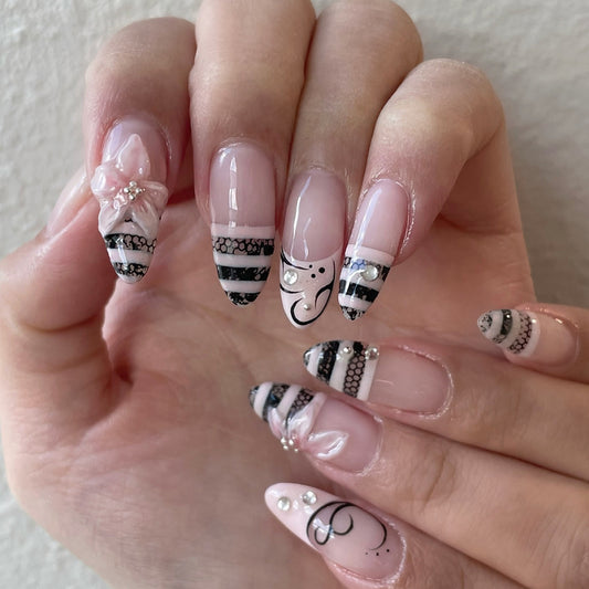 Elegant Enchantment Long Stiletto Pink and Black Striped Design with Floral Accents Nail Set