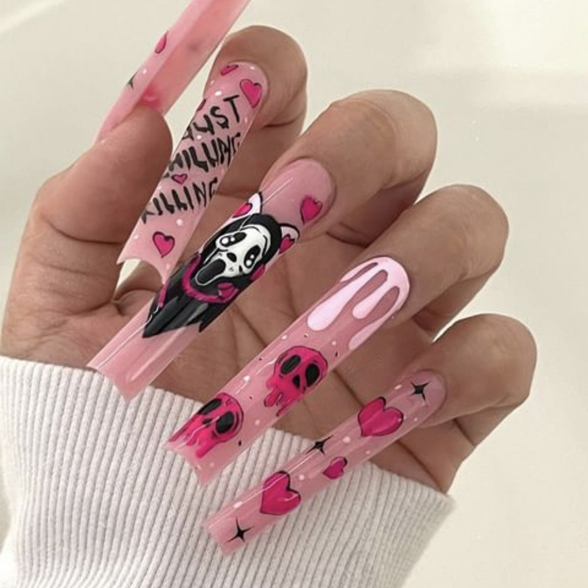 Kawaii Inspired Long Square Pink Nail Set With Heart And Skull Designs For A Unique Creative Look