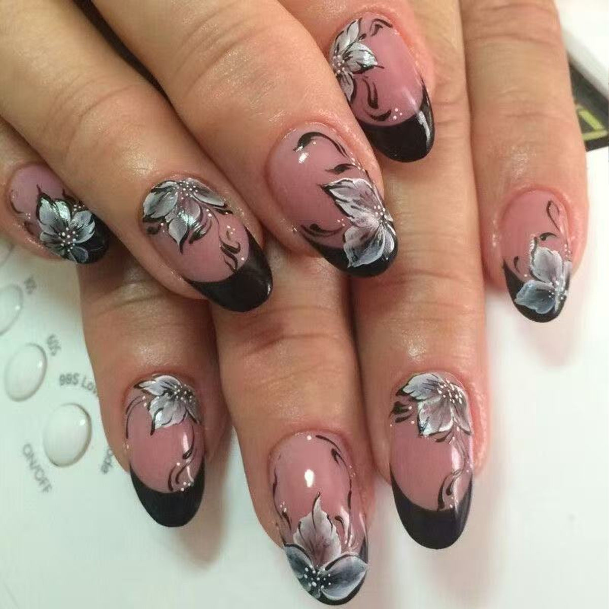 Elegant Floral Fantasy Press On Nail Set Short Oval Shape Beige with Black Tips and Intricate Flower Design