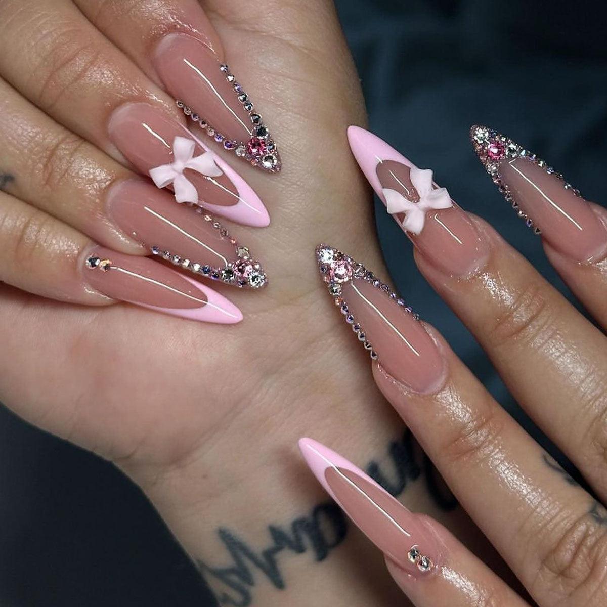 Chic Glamour Long Stiletto Pink Ombr√© Nail Set with Rhinestone Details and Bow Accents