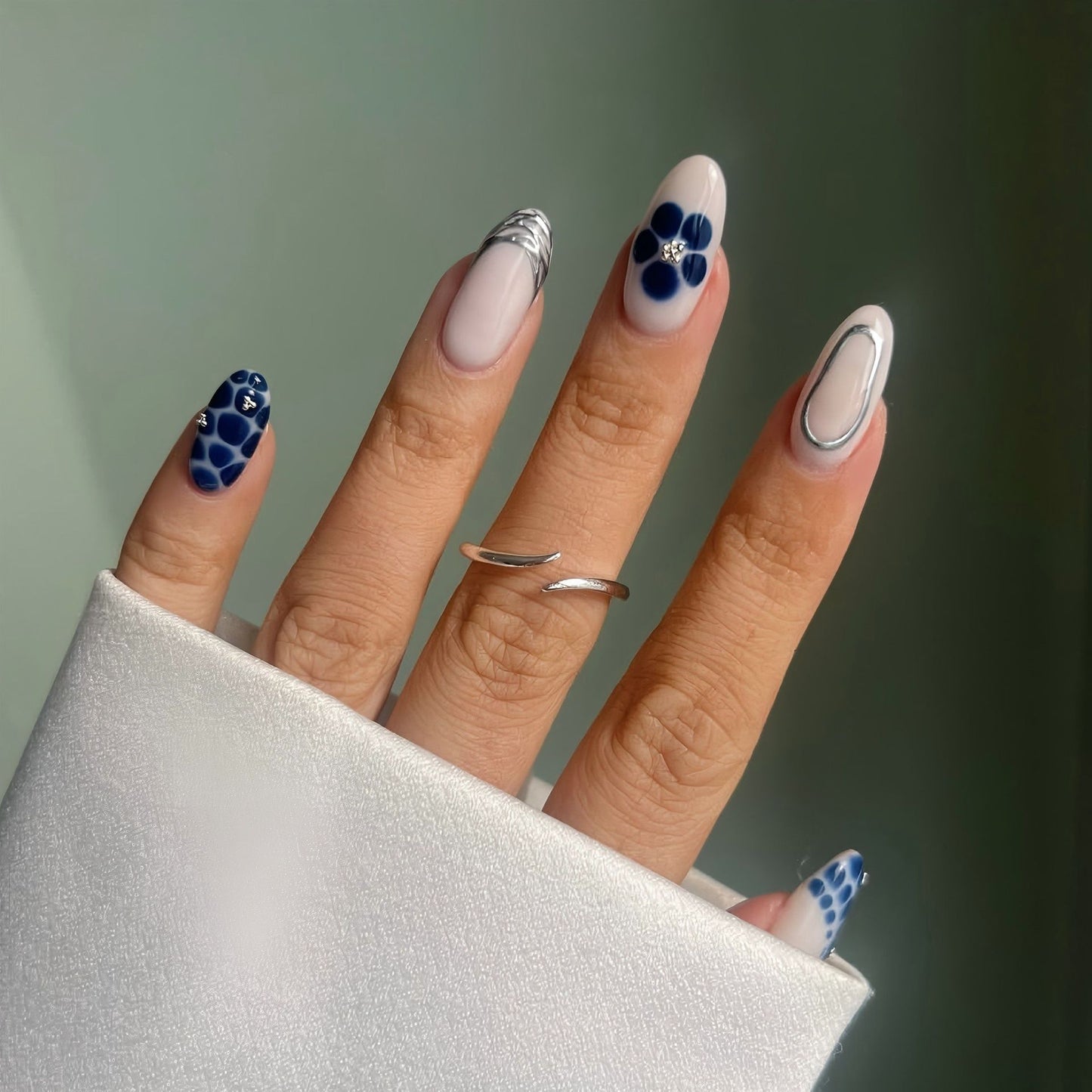 Nautical Elegance Medium Almond Blue and White Floral Press-On Nail Set with Shimmering Accent Design