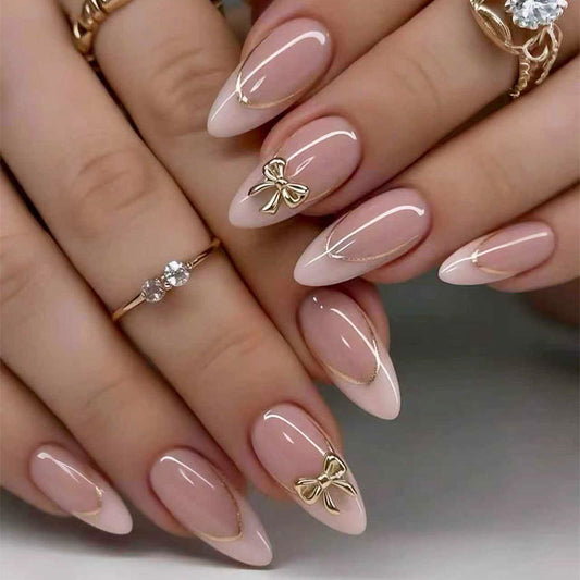 Charming Elegance Long Almond Pink Nails with Gold Accents and Unique Bow Design