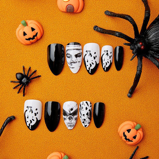A set of press-on nails featuring black and white ghostly portraits, displayed on an orange background with Halloween-themed decorations around.