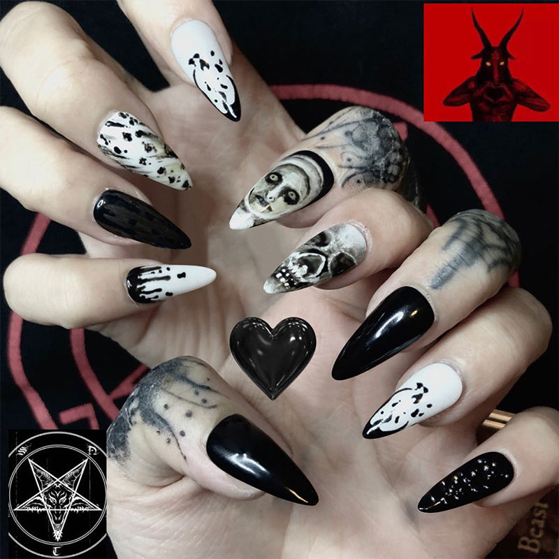 Gothic Elegance Medium Almond Black And White Press On Nail Set With Skull Accents And Artistic Splatter Design