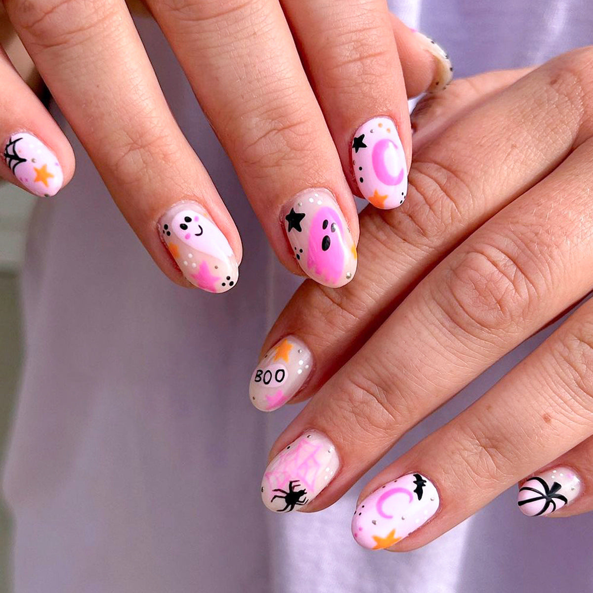 Spooky Elegance Short Length Oval Press On Nail Set in Pastel Pink with Halloween-Themed Artwork