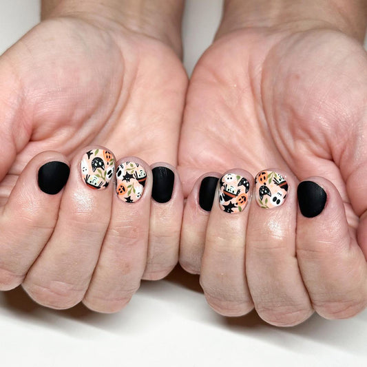 Enchanted Halloween Short Oval Black and Patterned Press On Nail Set with Cute Ghost Accents