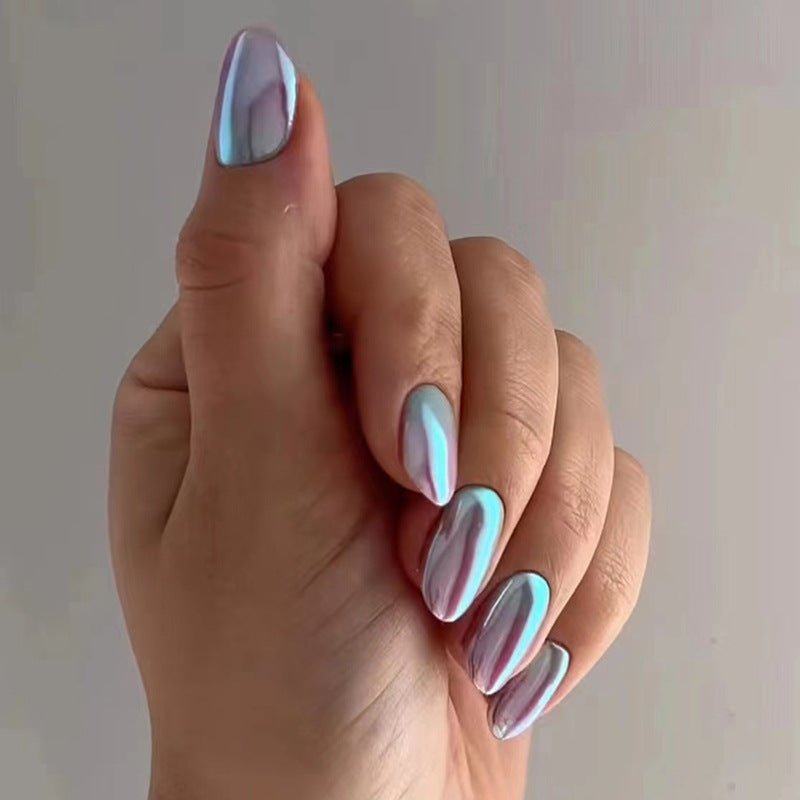 A hand showcasing medium almond-shaped press-on nails with an iridescent, color shifting feature, displaying opalescent hues.