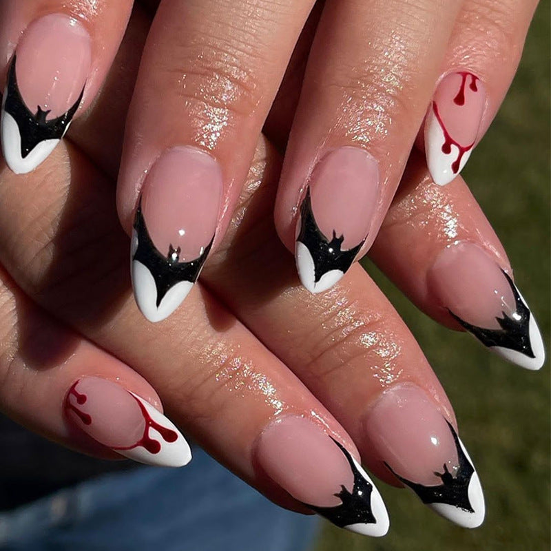 Gothic Elegance Medium Almond Black and White Bat Wing Accented Press On Nails with Red Drip Detail