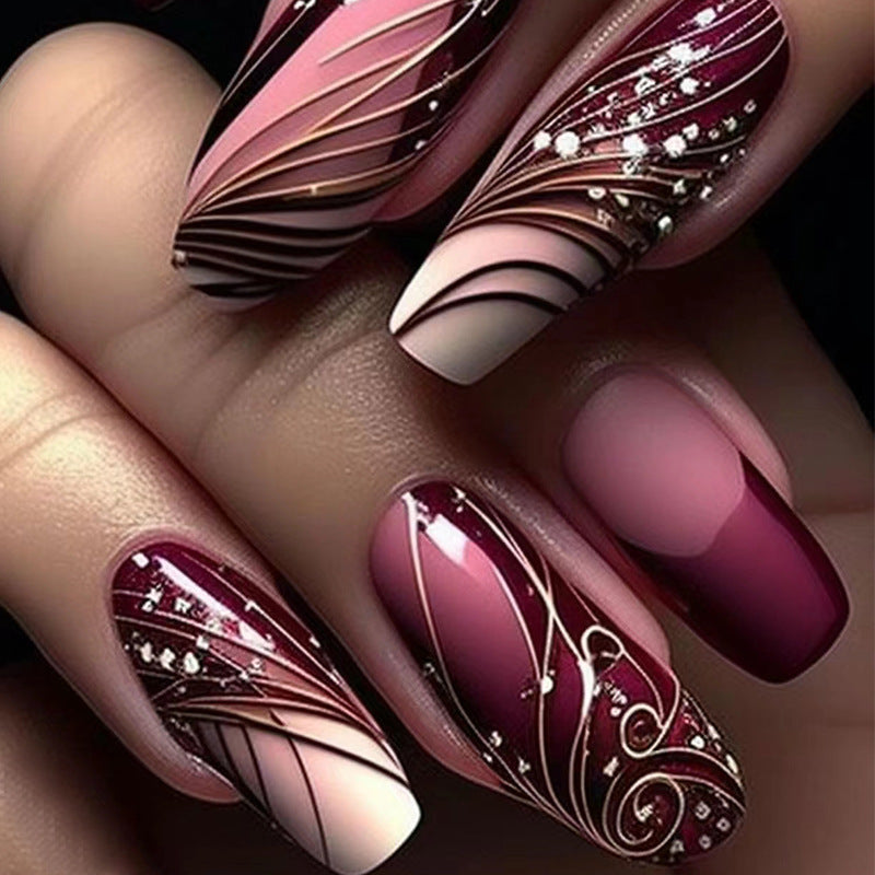 Enchanted Elegance Long Oval Burgundy Press On Nails with Glitter Accents and Artistic Swirl Design
