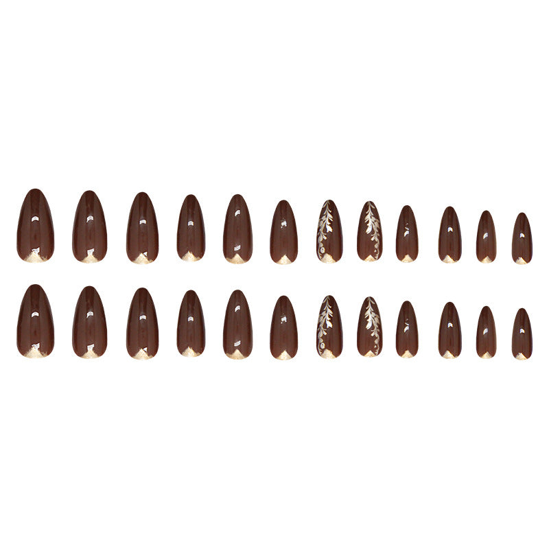 A set of almond-shaped glossy press-on nails in medium brown with chic gold accents