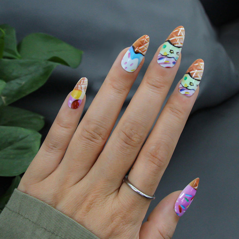 Hand with colorful ice cream-themed nail art on a dark background
