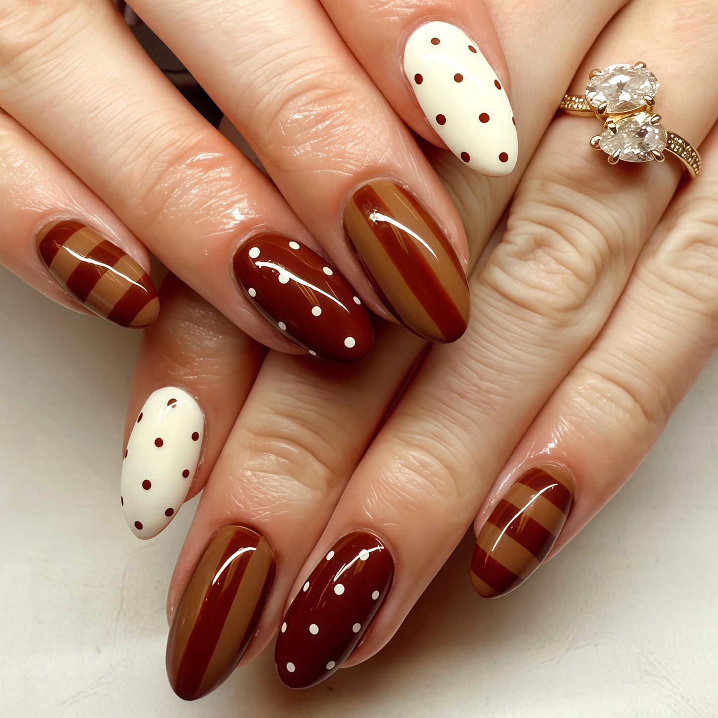 Chocolate Delight Medium Oval Shaped Brown and Cream Press-On Nail Set with Elegant Polka Dots and Stripes
