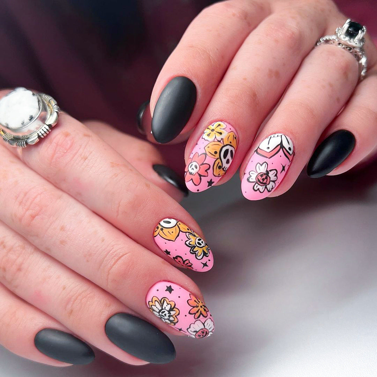 Boho Chic Medium Round Pink and Black Floral Press On Nail Set with Unique Skull Accent Design