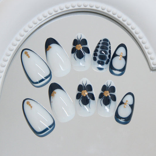 Elegant Garden Dreams Medium Almond Shaped White and Navy Nail Set with Floral Accents