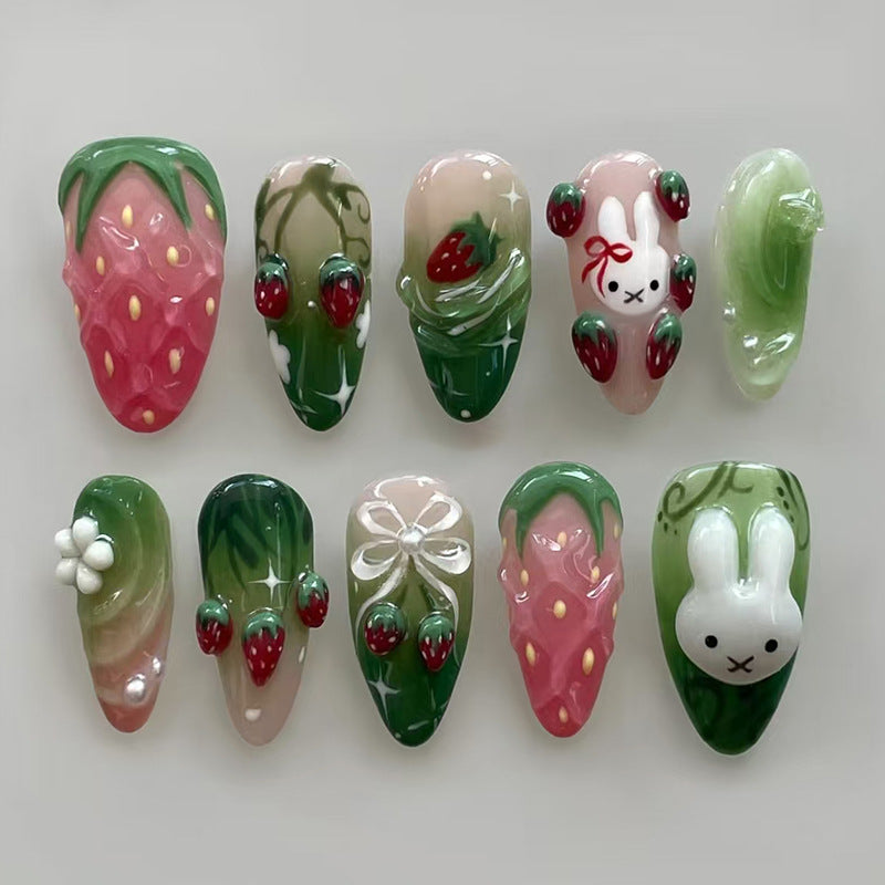 Whimsical Garden Press On Nail Set in Medium Almond Shape with Pastel Pink and Green Colors Featuring Adorable Bunny and Strawberry Designs