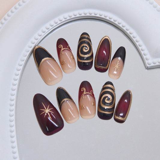Mystical Elegance Medium Almond Maroon and Black Nail Set with Intricate Gold Swirl Designs