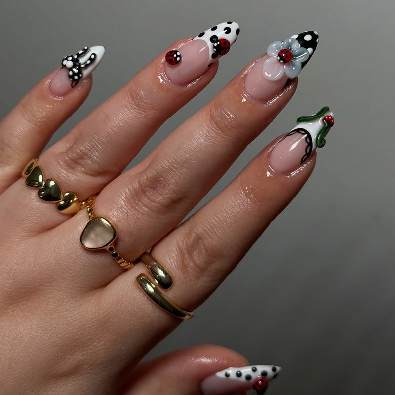 Whimsical Garden Long Almond Press On Nail Set in Bold Black and White with Charming Floral Accents