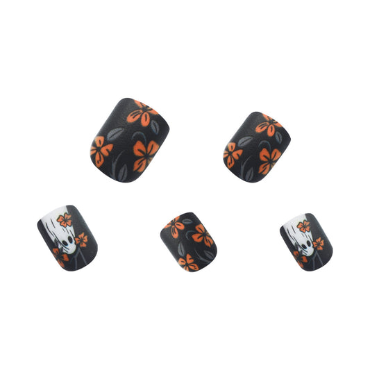 A set of four matte black press-on nails with a floral design in orange and white colors.