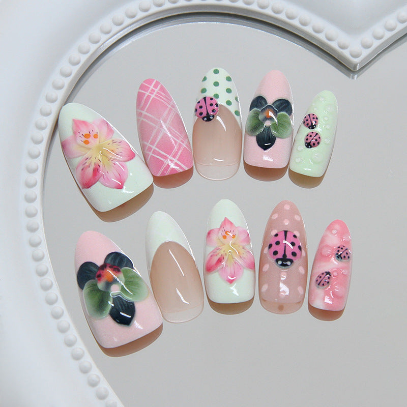 Whimsical Blossom Medium Almond Pink Nail Set with Vibrant Floral Artwork