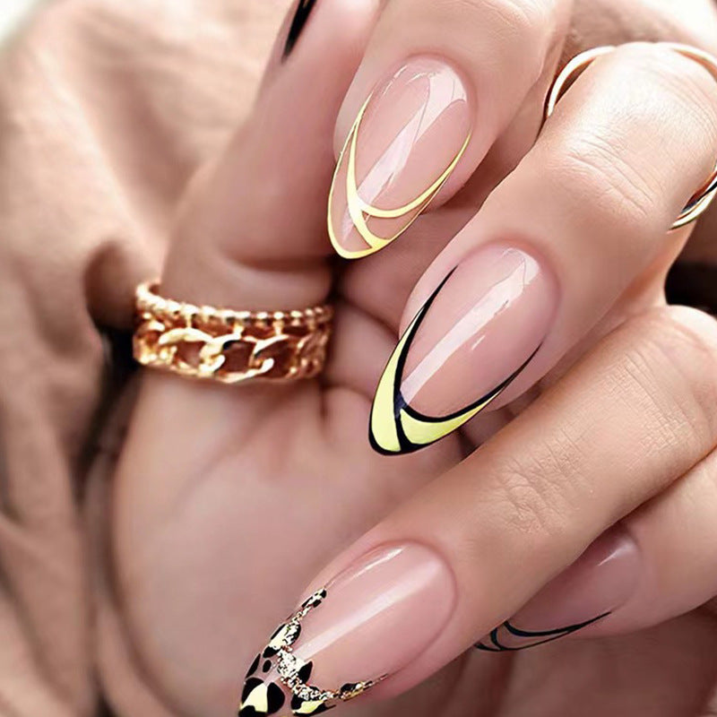 A set of press-on nails featuring almond-shaped nails with yellow and black design and stunning crystal accents.