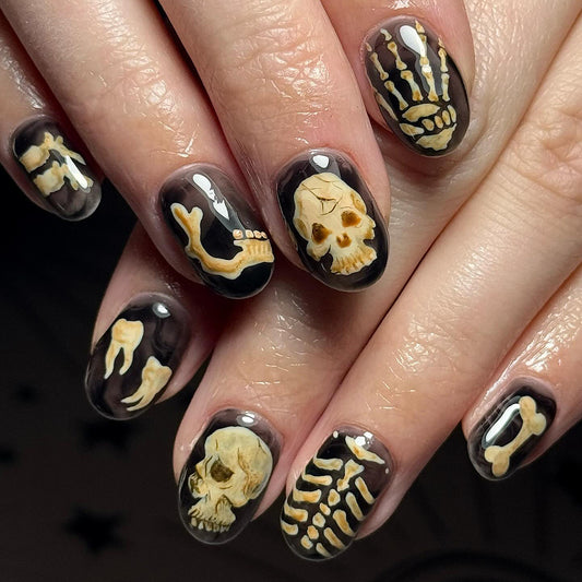 Spooky Skeleton Theme Medium Round Black and Beige Press On Nail Set with Unique Bone and Skull Designs