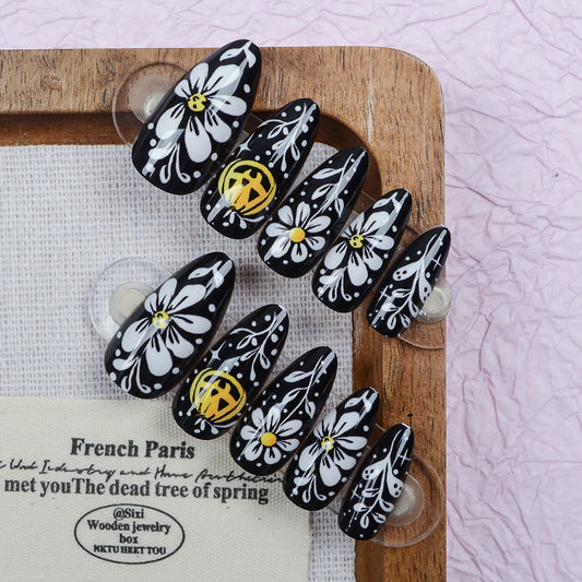 Chic Floral Delight Short Stiletto Black with Intricate White and Yellow Petal Design Nail Set