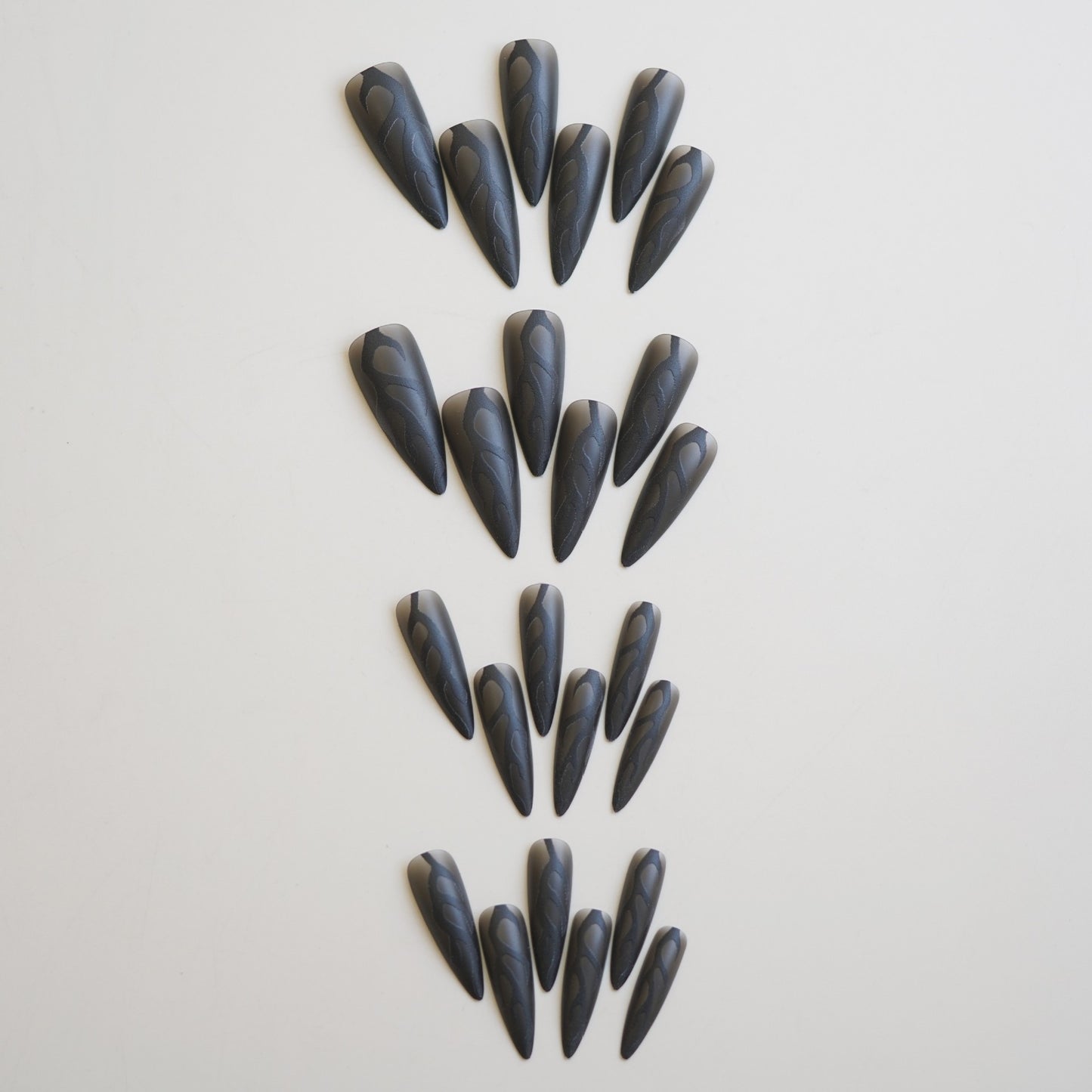 Mystical Elegance Long Almond Shaped Matte Black Press On Nail Set with Intricate Swirl Design