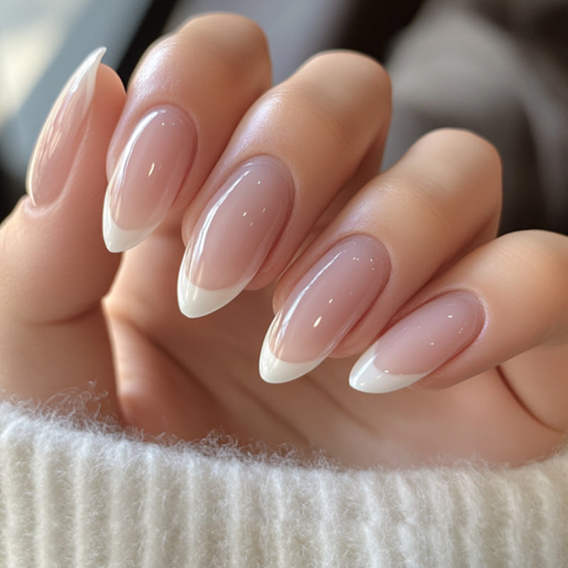 Close-up of a hand with almond-shaped nails and a soft pink color.