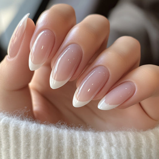 Close-up of a hand with almond-shaped nails and a soft pink color.