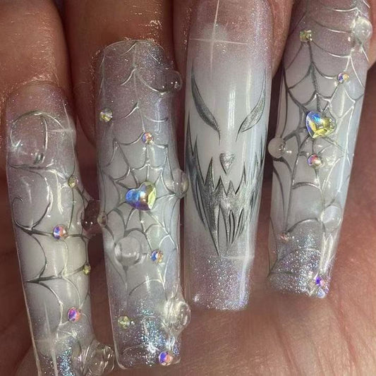 Spooky Chic Long Square Clear Nails with Intricate Spiderweb Design and Glittering Gem Accents