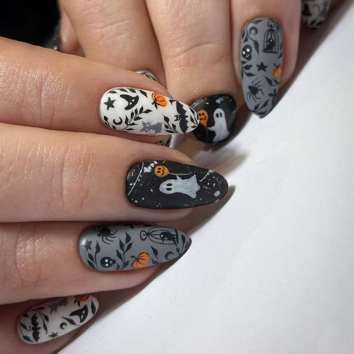 Spooky Chic Long Almond Black and White Nail Set with Haunting Halloween Designs