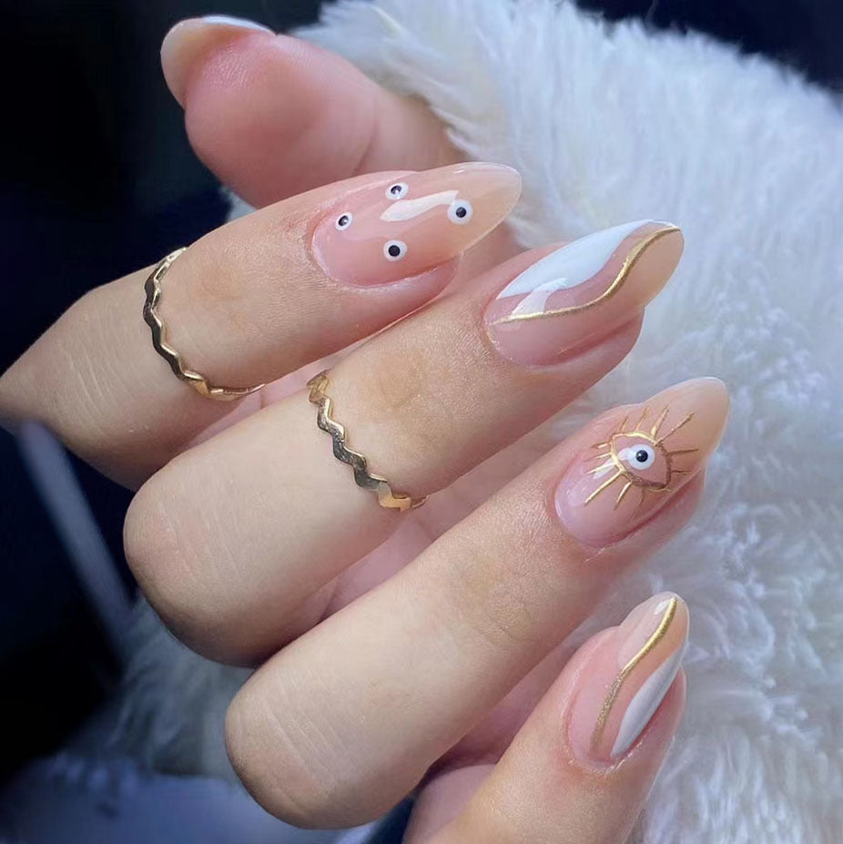 Mystical Eye Design Medium Almond Clear Press on Nail Set with Elegant Gold Accents and Unique Whimsical Features