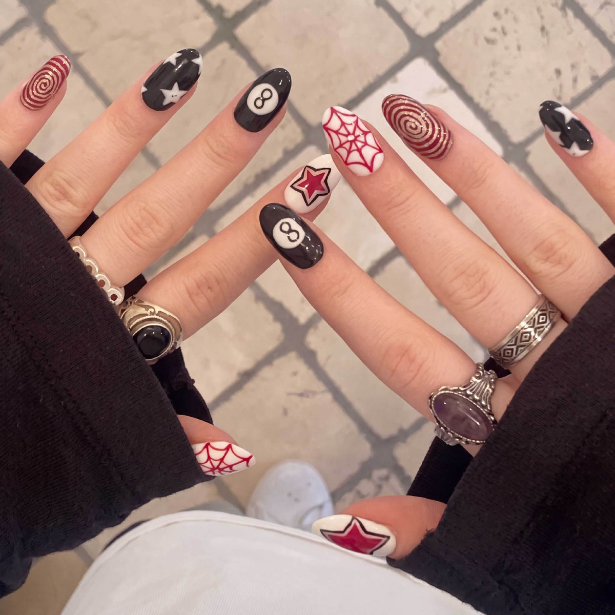 Spooky Elegance Medium Oval Black and Red Nail Set with Unique Graphic Designs