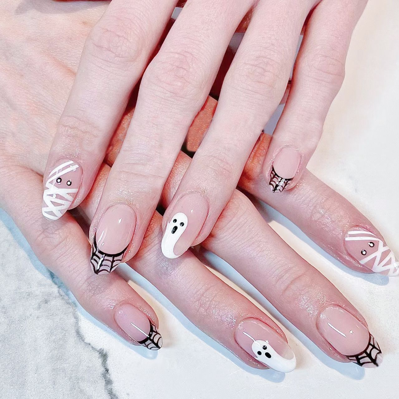 Spooky Halloween Theme Long Oval Shape Beige and White Press On Nail Set Featuring Ghost and Spider Web Designs