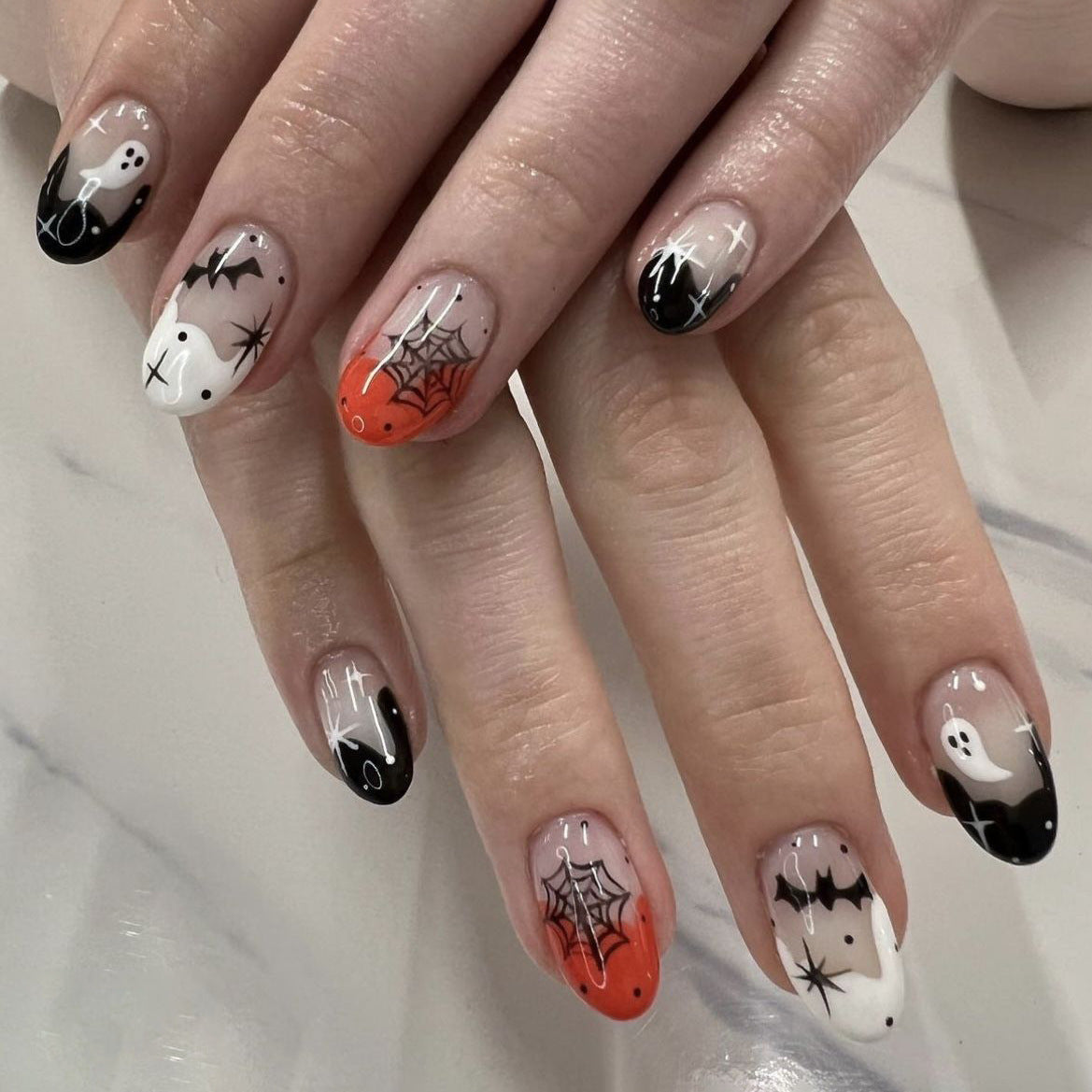Spooky Elegance Medium Oval Black and Orange Halloween Nail Set with Intricate Spider Web Design