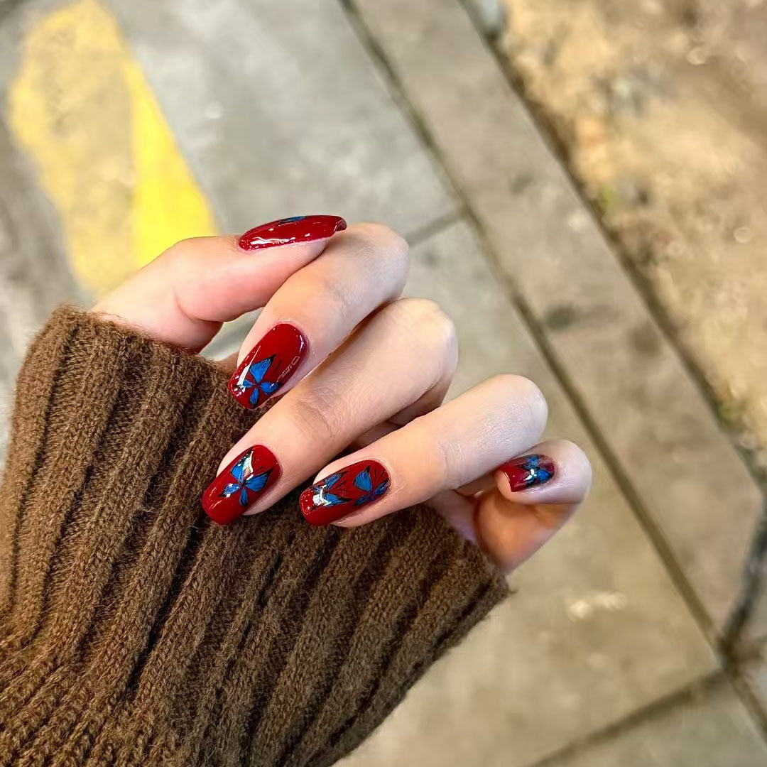 Autumn Elegance Medium Coffin Shaped Deep Red Nails with Vibrant Blue Floral Design