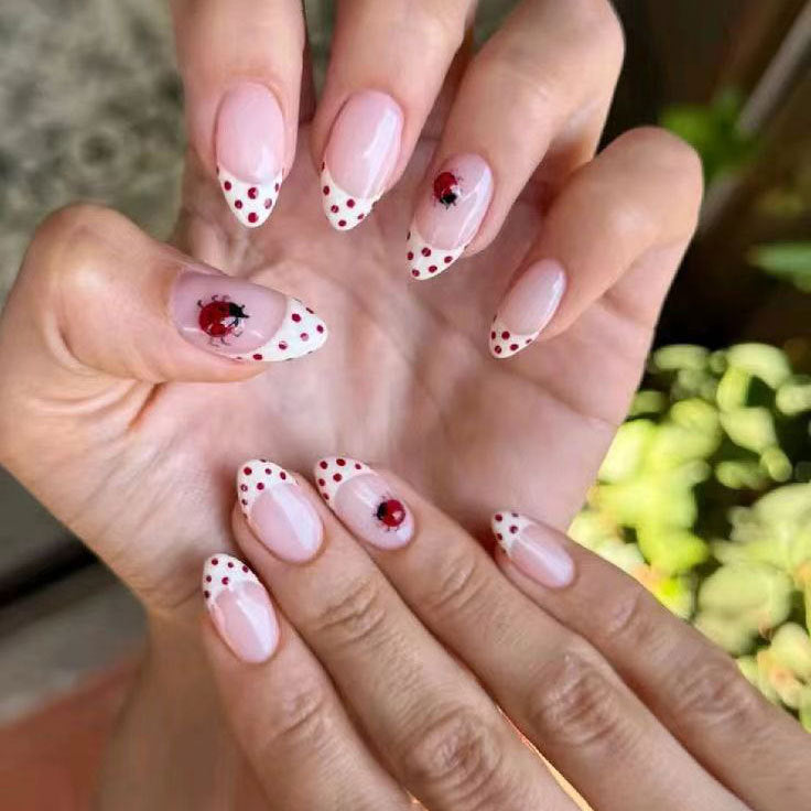 Whimsical Ladybug Inspired Long Almond Shaped Soft Pink Press On Nail Set with Charming Red Polka Dots and Stunning Ladybug Design