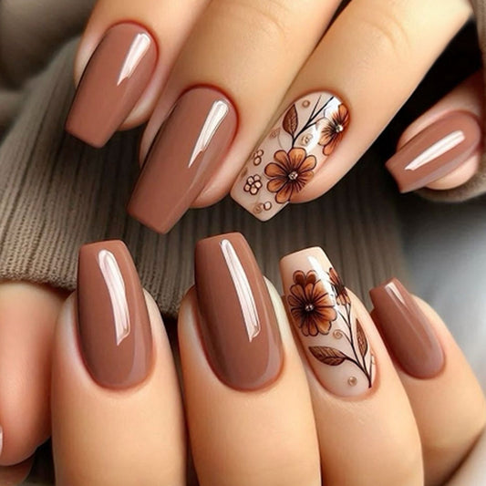 A set of press-on nails featuring a floral design with brown and beige colors.