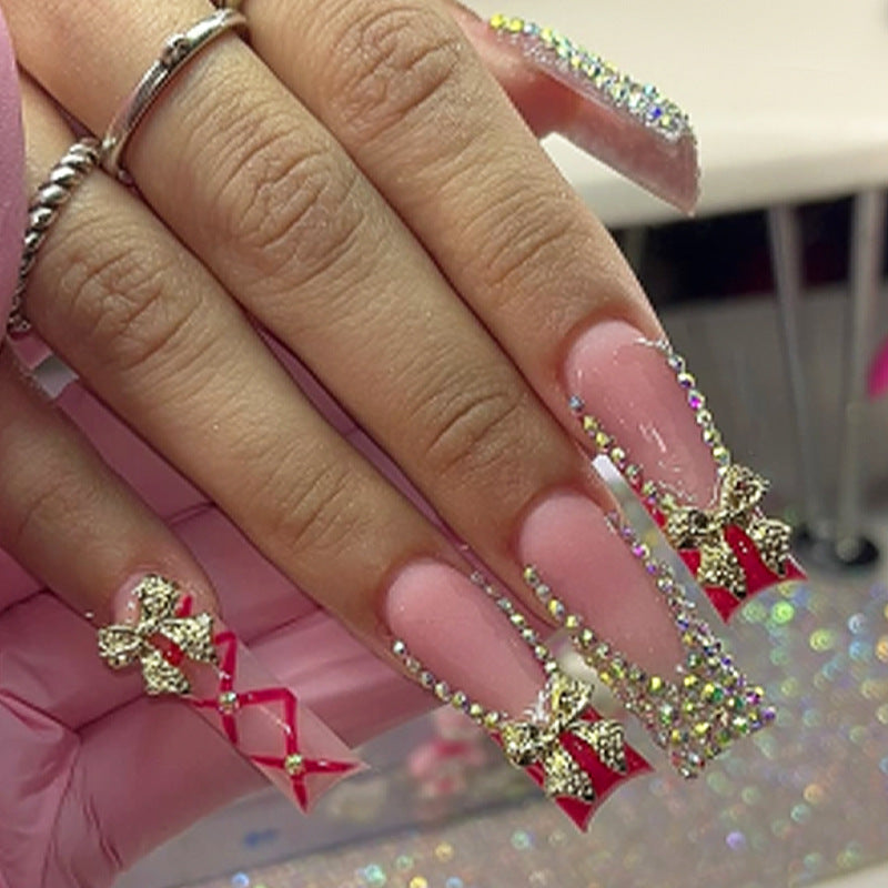 Whimsical Elegance Long Square Shaped Pink Nails with Sparkling Jewel Accents and Festive Bow Detail